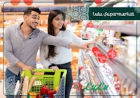 a man and a woman shopping in a supermarket