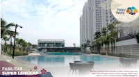 a swimming pool with a building in the background