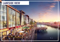 lakeside view is a shopping mall with people walking along the water