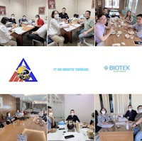 a group of people are sitting at a table in a conference room