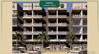 a rendering of an apartment building with cars in front of it