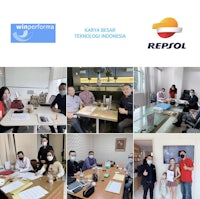 a group of people are sitting at a table in a conference room