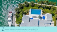 an aerial view of a house with a boat and a pool