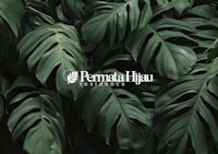 the logo for permata hiu on a background of green leaves