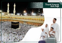 a family is standing in front of a kaaba at night