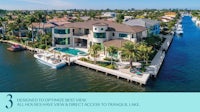 an aerial view of a house on a lake