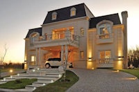 a house with a car parked in front of it at dusk