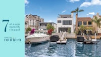 a group of boats are docked in front of a house